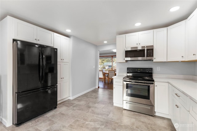 kitchen with appliances with stainless steel finishes and white cabinets