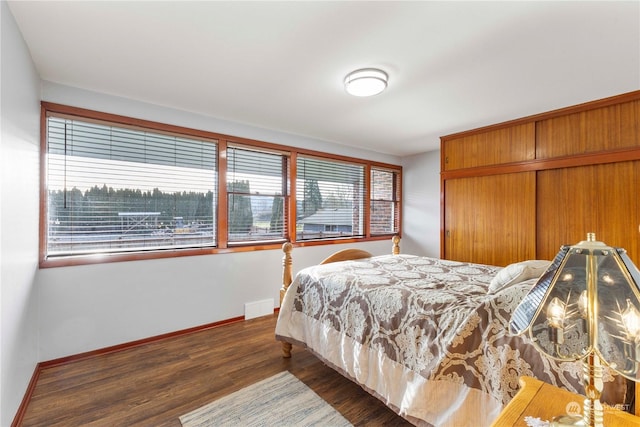 bedroom with dark hardwood / wood-style flooring