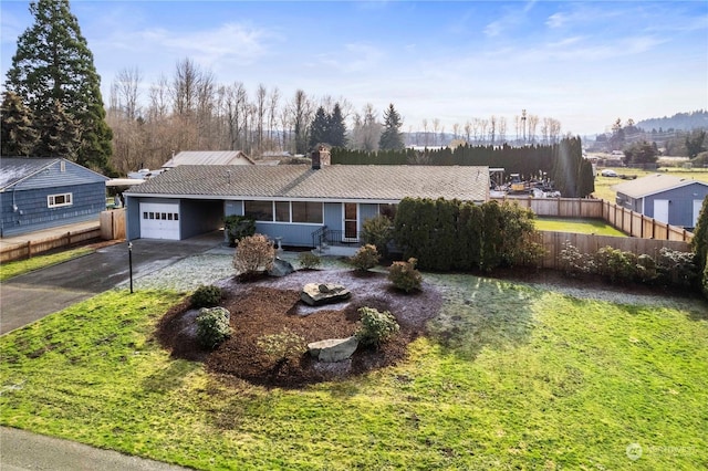 view of front of property featuring a garage and a front lawn