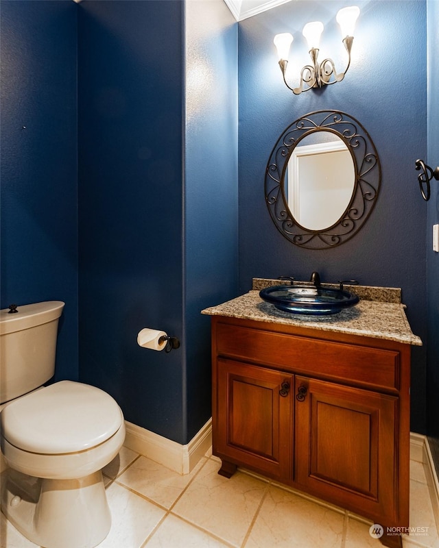 bathroom with tile patterned flooring, vanity, an inviting chandelier, and toilet