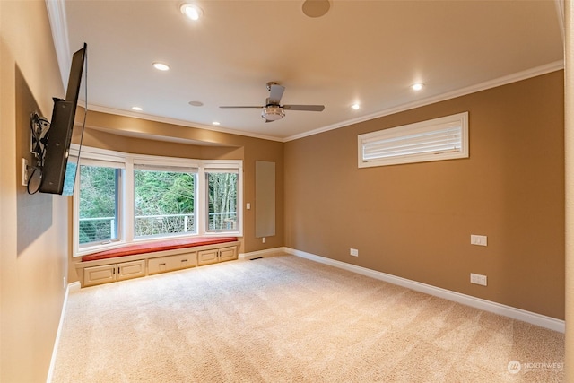 spare room featuring crown molding, ceiling fan, and carpet floors