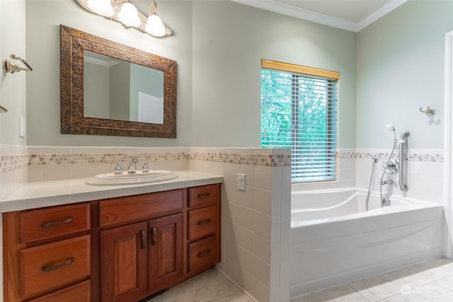 bathroom featuring vanity, crown molding, tile patterned floors, and a tub