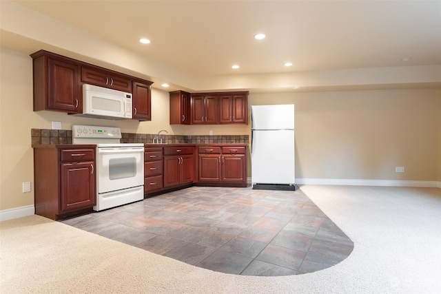 kitchen featuring light carpet, sink, and white appliances