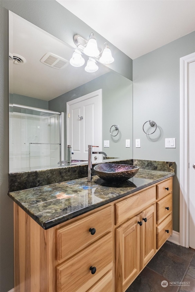 bathroom featuring vanity and a shower with shower door