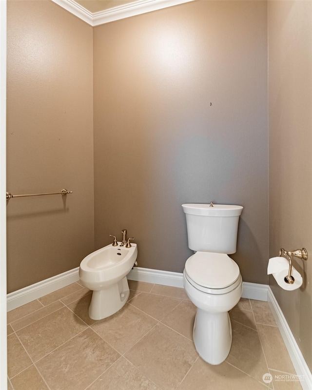 bathroom featuring a bidet, tile patterned flooring, crown molding, and toilet