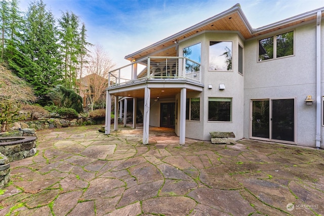 back of house with a patio and a balcony