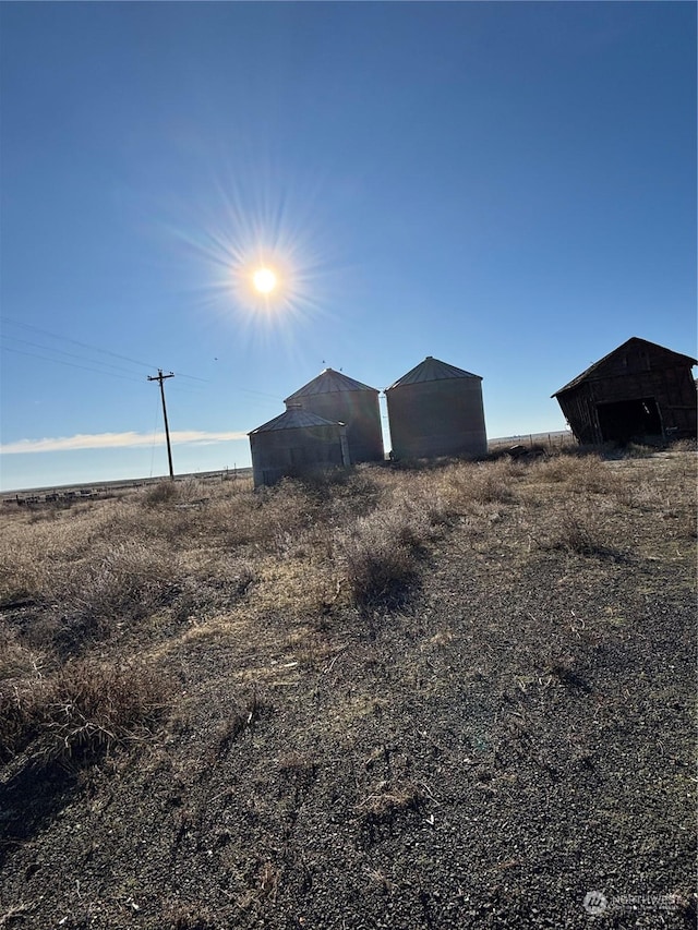 view of yard with a rural view