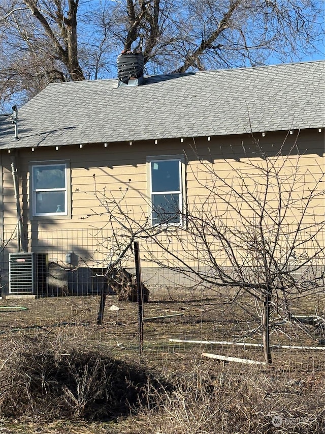 view of side of property featuring central AC