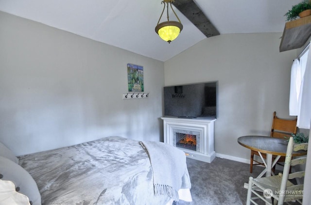 bedroom with vaulted ceiling with beams, dark carpet, and a fireplace