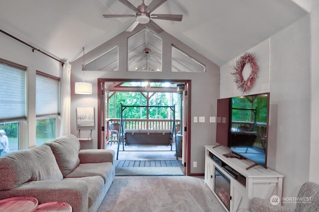 carpeted living room featuring ceiling fan and lofted ceiling