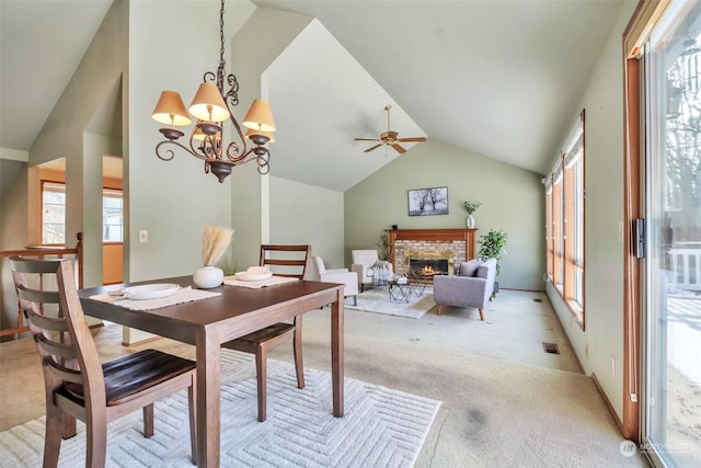 carpeted dining area with vaulted ceiling, a brick fireplace, and an inviting chandelier