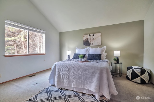 bedroom with vaulted ceiling and carpet floors