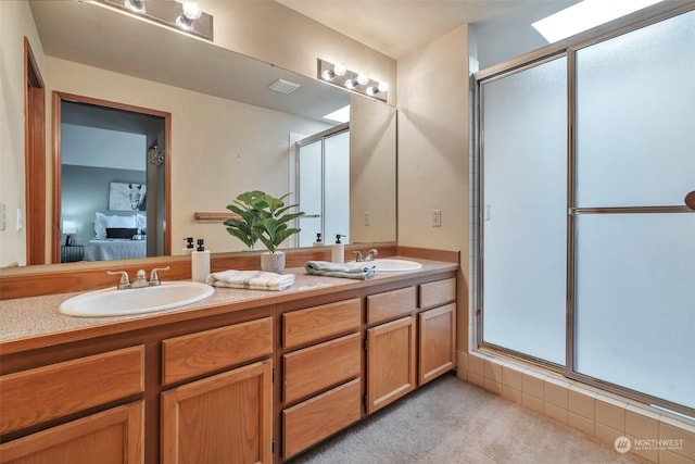 bathroom featuring vanity and a shower with door