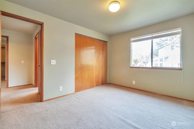 unfurnished bedroom with carpet floors and a closet