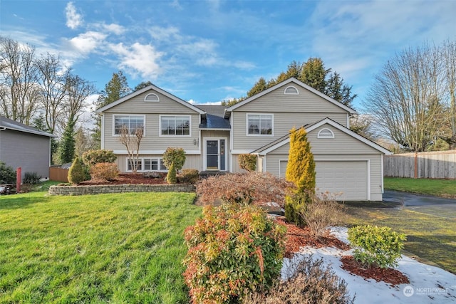 view of front of house featuring a garage and a front lawn