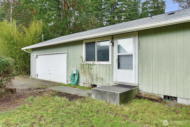 doorway to property featuring a garage and a shingled roof