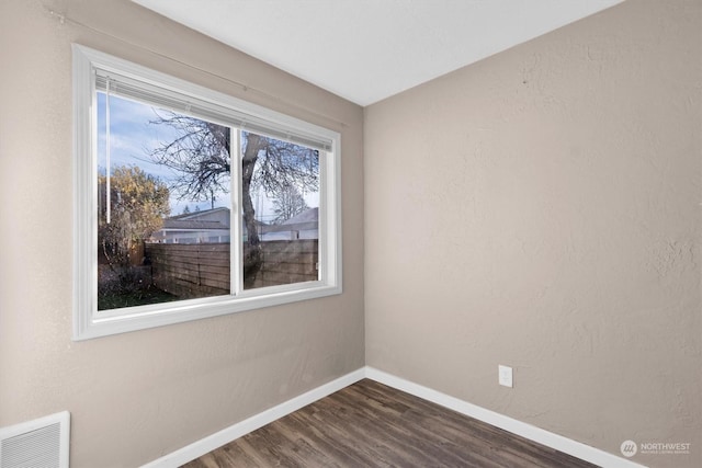 spare room with dark hardwood / wood-style flooring