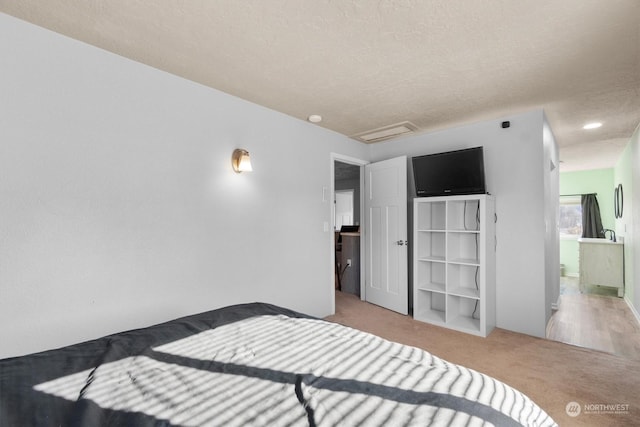 carpeted bedroom featuring a textured ceiling