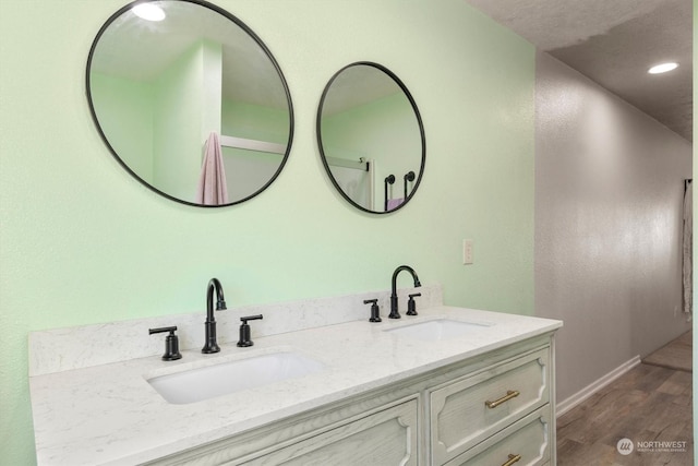 bathroom with vanity and wood-type flooring