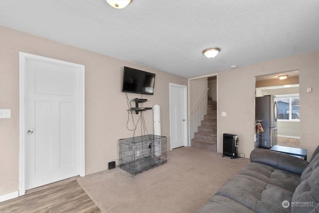 living room with hardwood / wood-style floors and a textured ceiling