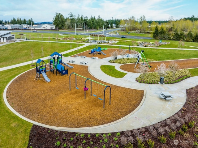 view of home's community with a playground and a yard