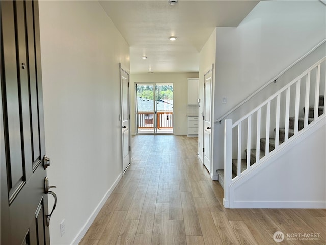 13414 187th Street Ct E Unit 20, Puyallup, WA 98374 - foyer with light wood finished floors, stairs, and baseboards