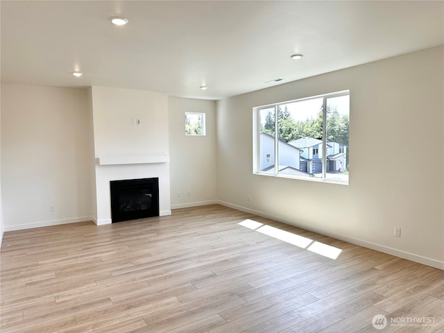13414 187th Street Ct E Unit 20, Puyallup, WA 98374 - unfurnished living room with light wood-style flooring, a fireplace, baseboards, and recessed lighting