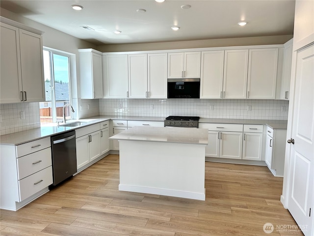 13414 187th Street Ct E Unit 20, Puyallup, WA 98374 - kitchen featuring appliances with stainless steel finishes, a sink, light countertops, a center island, and decorative backsplash