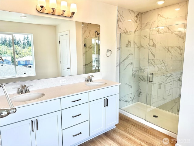 13414 187th Street Ct E Unit 20, Puyallup, WA 98374 - bathroom with a marble finish shower, double vanity, recessed lighting, and wood finished floors