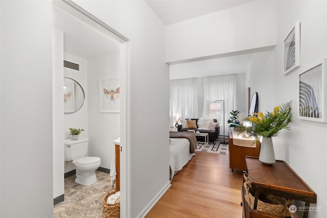 hallway with light hardwood / wood-style flooring