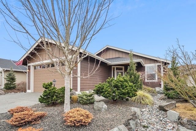 view of front of home with a garage, driveway, and board and batten siding