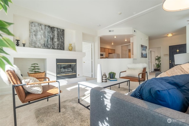 living room featuring vaulted ceiling and light carpet