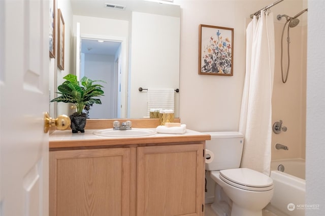 full bathroom featuring vanity, shower / bath combo, and toilet