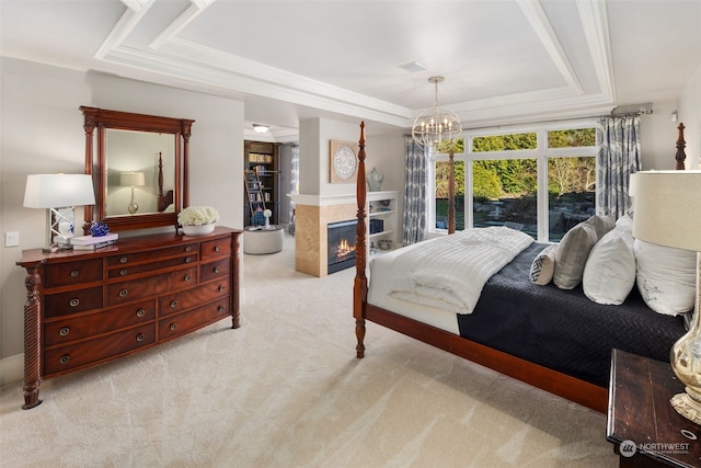 bedroom with light carpet, a raised ceiling, and a chandelier