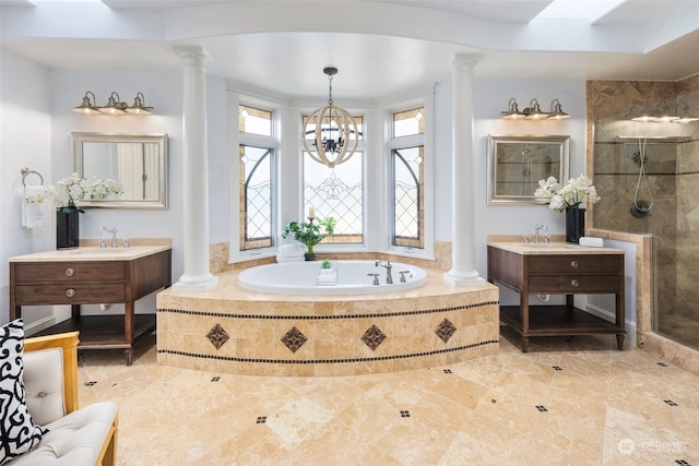 bathroom with decorative columns and separate shower and tub