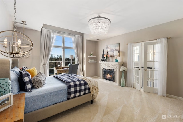 bedroom with light carpet and an inviting chandelier