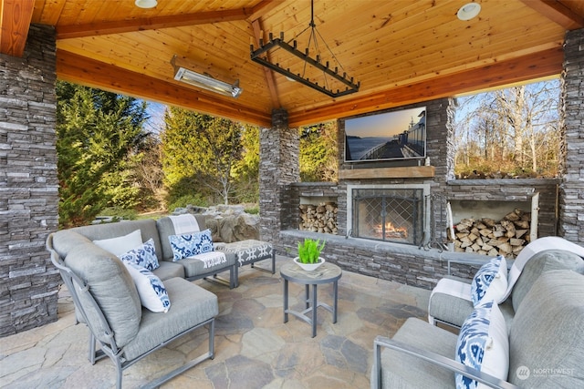 view of patio / terrace featuring a gazebo and an outdoor stone fireplace