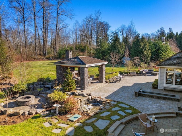 view of patio featuring a gazebo and an outdoor fire pit