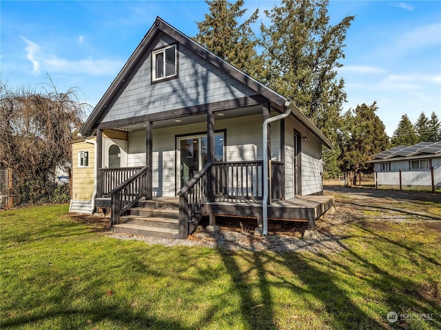 bungalow-style home with a front lawn and a porch