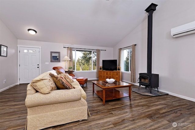 living room featuring dark hardwood / wood-style floors, a wall mounted AC, vaulted ceiling, and a wood stove