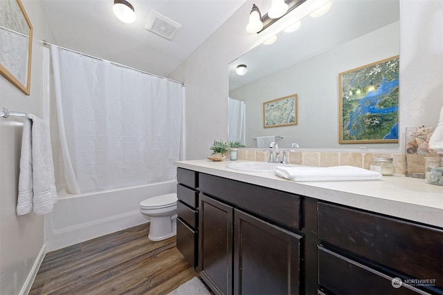 full bathroom with vanity, hardwood / wood-style floors, shower / bath combo, and toilet