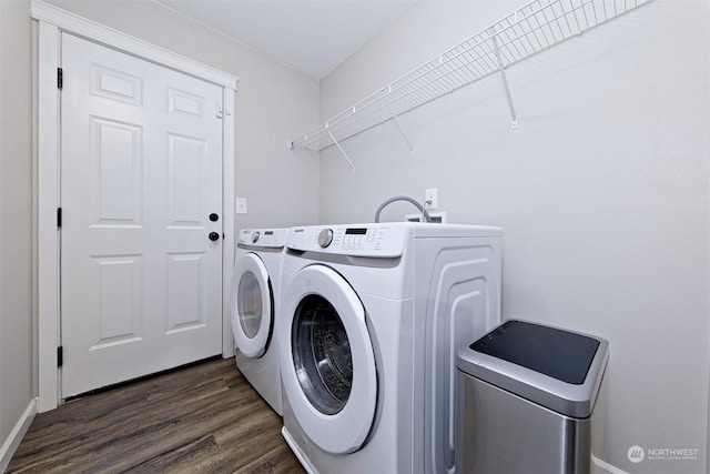 laundry room featuring dark wood-type flooring and washer and clothes dryer