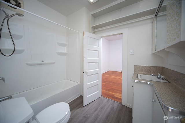 full bathroom featuring toilet, vanity,  shower combination, and wood finished floors