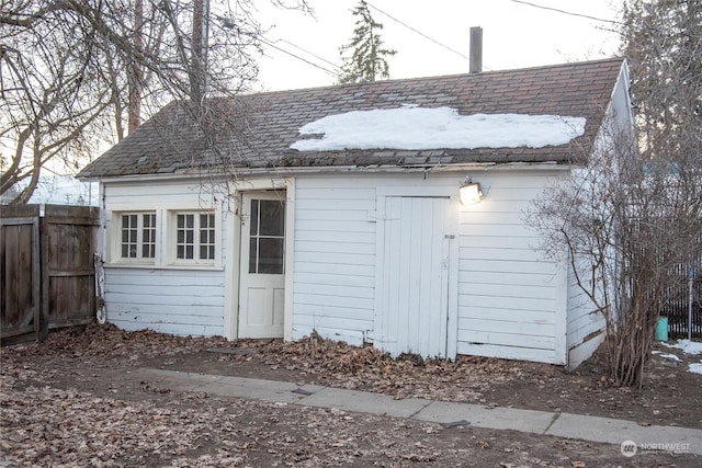 view of outbuilding with fence