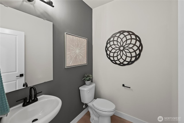 6612 6th St E, Tacoma, WA 98424 - half bathroom with a sink, baseboards, and toilet