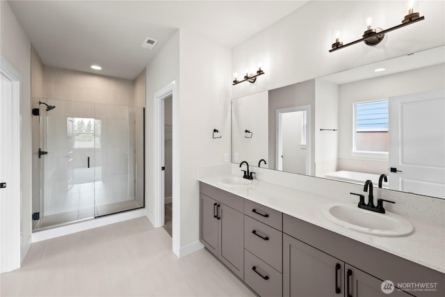 6612 6th St E, Tacoma, WA 98424 - full bath with a stall shower, baseboards, double vanity, a bath, and recessed lighting