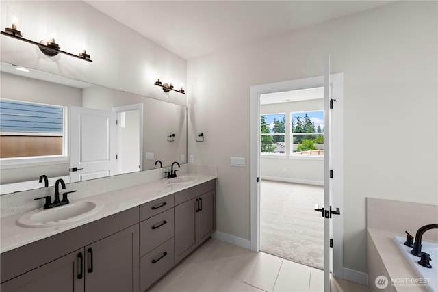 6612 6th St E, Tacoma, WA 98424 - bathroom featuring baseboards, tile patterned floors, double vanity, and a bath