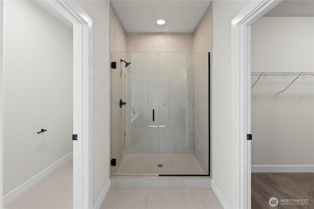 6612 6th St E, Tacoma, WA 98424 - full bathroom with a stall shower, a walk in closet, and baseboards