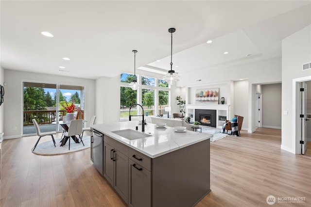 6612 6th St E, Tacoma, WA 98424 - kitchen featuring a sink, gray cabinetry, a glass covered fireplace, baseboards, and recessed lighting