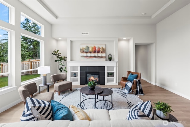 6612 6th St E, Tacoma, WA 98424 - living room with wood finished floors, a fireplace, baseboards, and a raised ceiling
